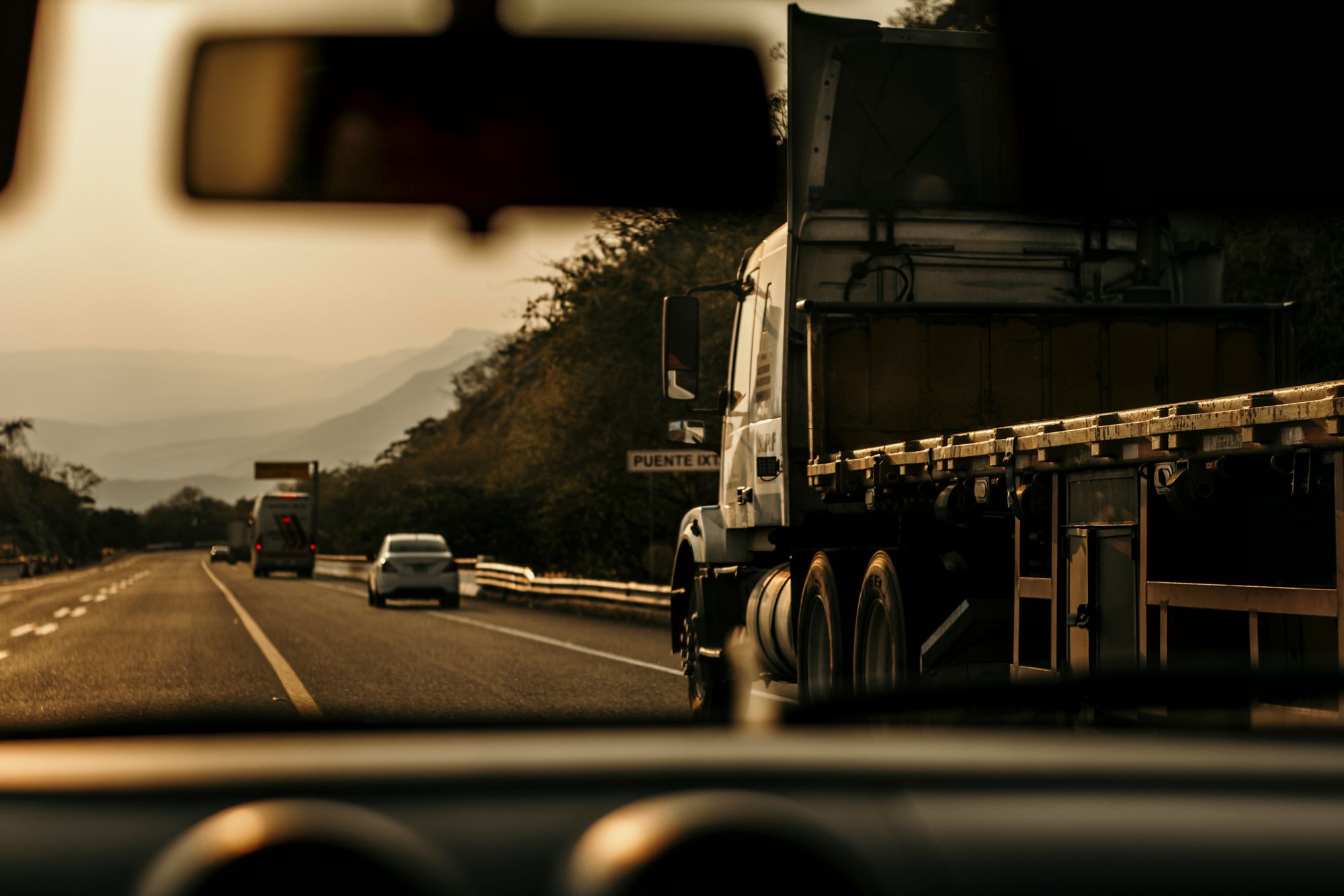 A tractor-trailer rolling down the interstate at golden hour